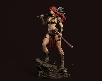 May include: A detailed figurine of a warrior woman with red hair, clad in bronze armor and a red skirt. She holds an axe over her shoulder and a sword at her side, standing on a rock with skulls and weapons at her feet.