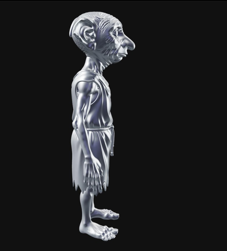 May include: A silver-colored figurine of a slender humanoid figure with a large nose and ears, wearing a tunic and skirt. The figure has a detailed face and is standing with its arms at its sides. The figurine is on a black background.