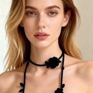 May include: A black choker necklace with a rose and leaf design. The necklace features a braided cord and a large rose at the center, with additional floral accents. The text "Printables Paradise" is in the upper right corner.