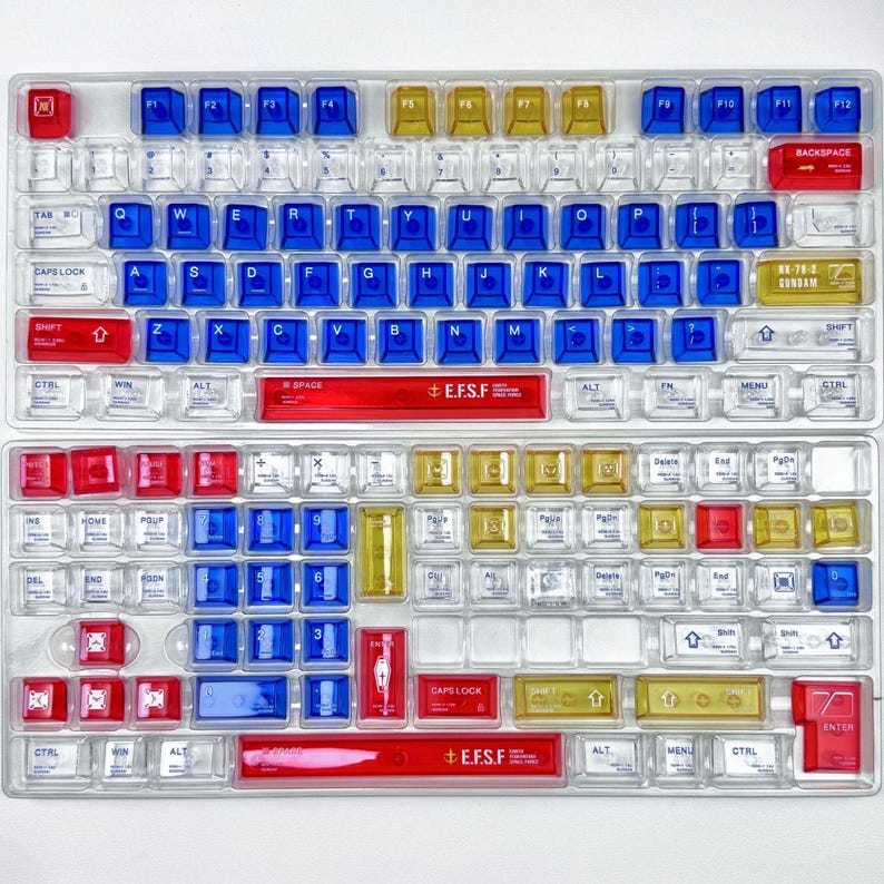 May include: A set of three ceramic mugs with a speckled, cream-colored glaze. Each mug features a different hand-painted floral design in shades of blue, green, and yellow. The mugs have a simple, rounded shape and a comfortable handle.