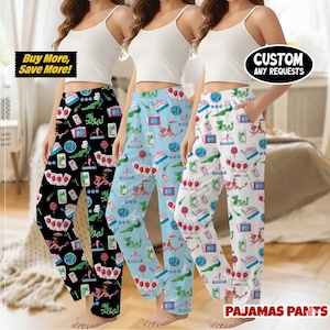 May include: Three pairs of pajama pants with colorful patterns. One pair is black, another is light blue, and the third is white. Each pair features a repeating design of various illustrations. The text "Buy More, Save More!" and "Custom Any Requests" are visible.