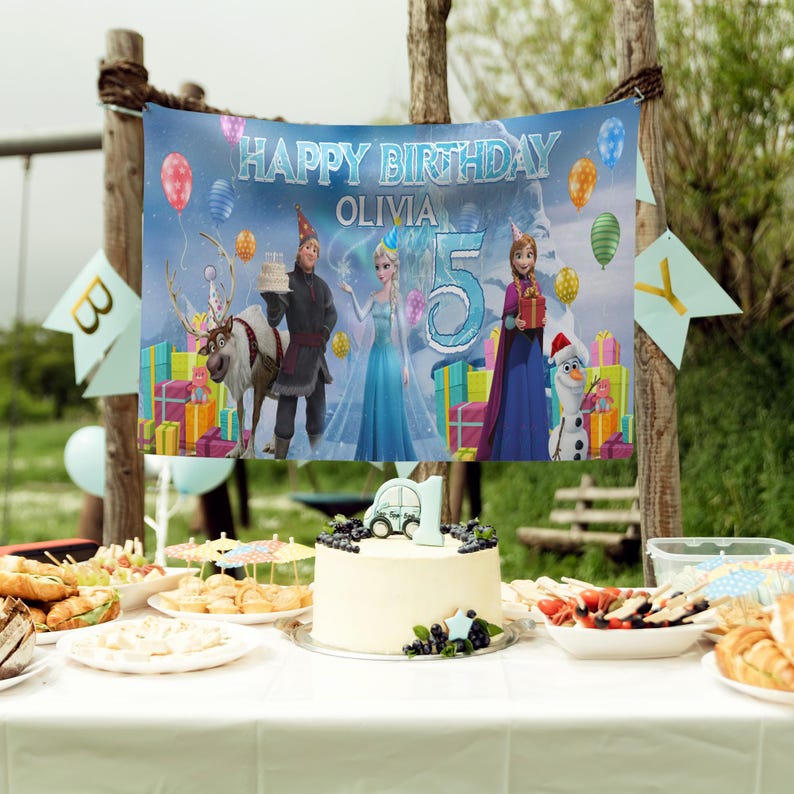 May include: A birthday party scene with a banner that reads "Happy Birthday Olivia 5". The banner features characters from the movie Frozen, balloons, and gift boxes. A cake with a car on top and other food items are on a table.