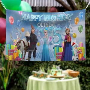 May include: A banner with the text "HAPPY BIRTHDAY OLIVIA 5" featuring characters from the movie Frozen. The banner has a blue background with balloons, presents, and images of Elsa, Anna, Kristoff, Olaf, and Sven.
