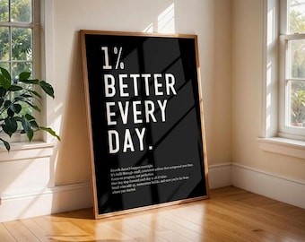 May include: A rectangular framed wall art piece with a black background and white text that reads 1% BETTER EVERY DAY, followed by a paragraph of smaller text about growth, progress, and small consistent actions that compound over time.