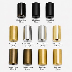 May include: A collection of cylindrical metal objects in various finishes, including black, brass, and chrome. The finishes range from glossy to matte, with labels indicating the material and finish type. The objects are arranged in rows and columns against a white background.