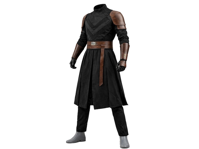 May include: A black costume with a high collar, brown shoulder pads, and matching arm guards. The outfit includes a brown belt, a long black skirt, black gloves, and black pants. The costume is completed with gray boots.