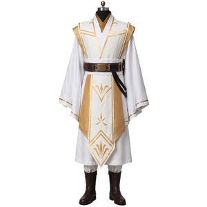 May include: A white and gold costume with a high collar, long sleeves, and a brown belt. The costume features gold accents on the shoulders, chest, and sleeves. Brown boots complete the outfit. The costume is displayed on a mannequin.