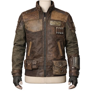 May include: A brown leather jacket with a distressed, vintage look. The jacket features multiple pockets, patches, and a zipper closure. The sleeves are a darker shade of brown, and the jacket has a stand-up collar. The jacket is displayed on a mannequin.
