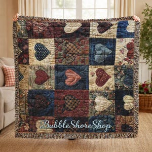 May include: A patchwork throw blanket featuring heart designs in red, blue, and cream. The blanket has a fringed edge and the text "BubbleShoreShop" is visible at the bottom.