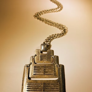 Vintage 1970s Modernist Articulated Pendant Necklace, Signed CMI. Features 3 Tiered, Brushed Gold-Tone Metal Plates w/ Distinctive Geometry