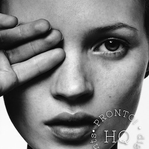 May include: Black and white close-up portrait of a person with their hand covering one eye. The image is high-contrast, emphasizing facial features like the lips, nose, and eye. The image has a watermark that says "PRONTO HQ digital prints."