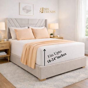 May include: A bed with a white fitted sheet, peach-colored pillows, and a matching throw blanket. The bed frame is beige, and the headboard has a geometric design. Text on the image reads "Fits Upto 18-24" inches".
