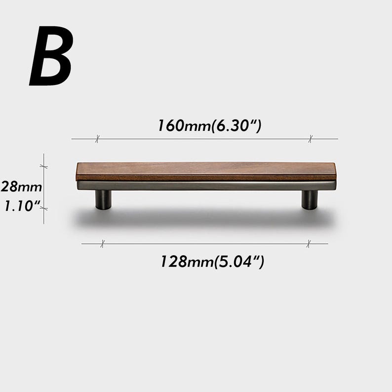 May include: A cabinet pull with a dark wood top and a silver-coloured base. The pull is 160mm long and 28mm high. The distance between the screw holes is 128mm. The letter "B" is in the upper left corner.