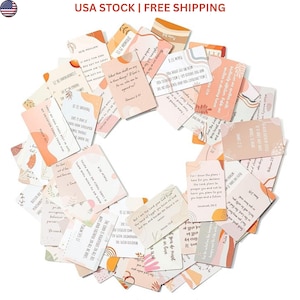 May include: A collection of rectangular cards arranged in a circular pattern, each featuring printed Bible verses and inspirational text. The cards display a color palette of soft peach, cream, and terracotta, accented with abstract shapes and botanical line art.
