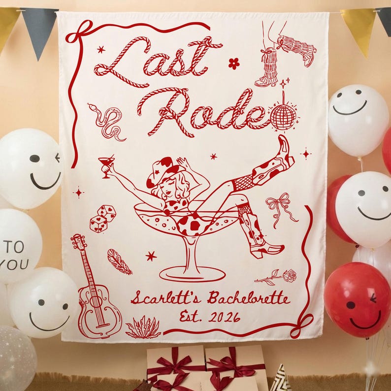 May include: A white fabric banner with red illustrations and text. The banner features a cowgirl in a martini glass, the words "Last Rodeo," and "Scarlett's Bachelorette Est. 2026." Decorative elements include a snake, dice, and a guitar. Balloons surround the banner.