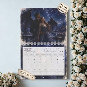 May include: A 2027 wall calendar featuring a fantasy illustration of a winged figure and a person in a gown under a starry night sky. The calendar page for January 2027 displays a grid with the text To the people who look at the stars and wish.
