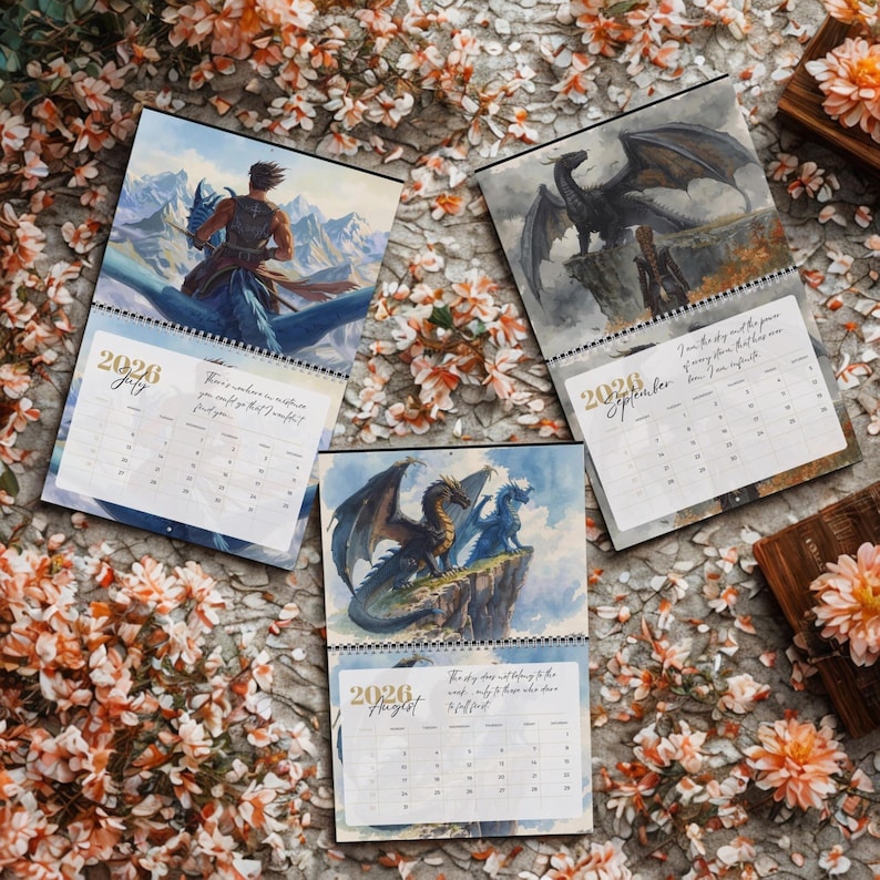 May include: Three 2026 wall calendars featuring fantasy illustrations of dragons and riders. The July page shows a rider on a blue dragon, August depicts two dragons on a cliff, and September shows a black dragon with a person in a landscape.
