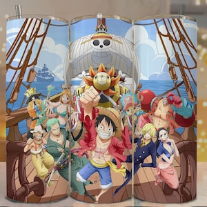 May include: A tumbler featuring a vibrant illustration of characters from the anime series One Piece. The design includes a ship, the Sunny, and various characters in dynamic poses, set against a blue sky and ocean background.