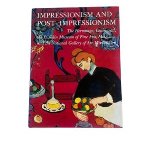 May include: A hardcover book titled Impressionism and Post-Impressionism: The Hermitage, Leningrad, the Pushkin Museum of Fine Arts, Moscow, and the National Gallery of Art, Washington, featuring a colorful painting of a person with fruit.