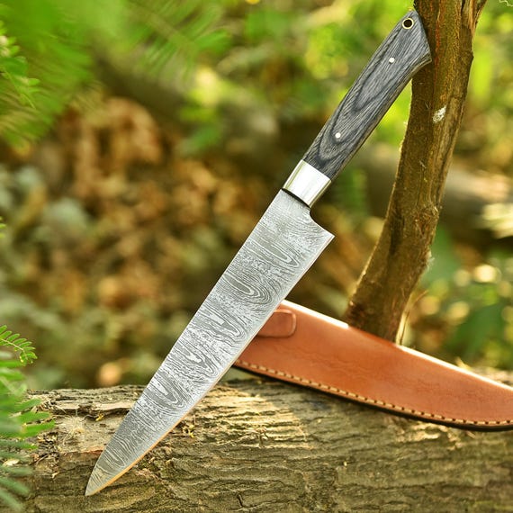 Hand-forged Damascus steel with a hypnotic swirling pattern and an exotic rosewood handle — a working kitchen knife that doubles as wearable art.