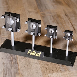 May include: A set of three ceramic mugs with a speckled, matte finish. The mugs are in shades of cream, light grey, and dark grey. Each mug has a simple, minimalist design, ideal for coffee or tea.