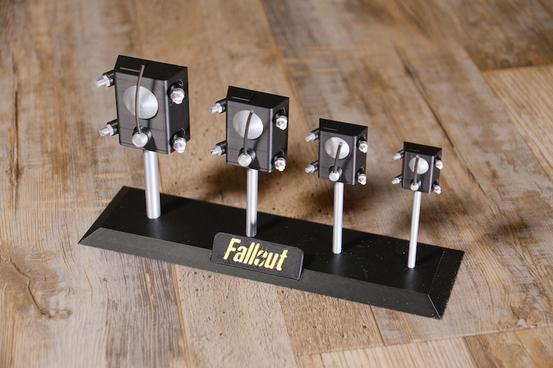 May include: A set of three ceramic mugs with a speckled, matte finish. The mugs are in shades of cream, light grey, and dark grey. Each mug has a simple, minimalist design, ideal for coffee or tea.