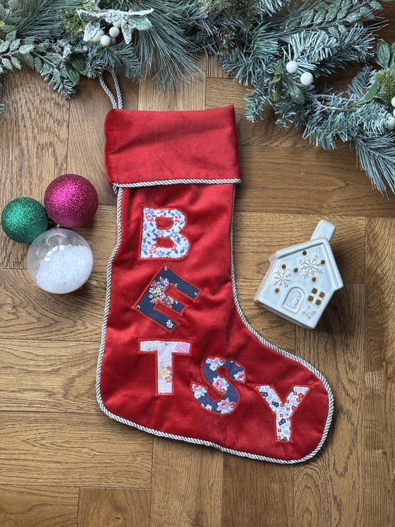 A Christmas stocking sewn from someone's actual cherished clothing — a genuinely sentimental, one-of-a-kind heirloom that a print-on-demand shop could never replicate.