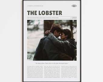 May include: A framed movie poster for "The Lobster" film. The poster features the film's title in bold, dark green letters, with the names of the actors below. A photo of two people embracing is in the center. The year 2015 is in the upper right corner.