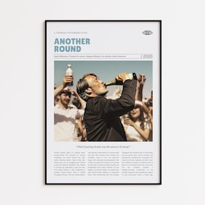 May include: A framed movie poster for "Another Round" features a man drinking from a beer bottle, with a crowd in the background. The poster includes the film's title, cast, and the year 2020. The text "What if getting drunk was the answer all along?" is also visible.