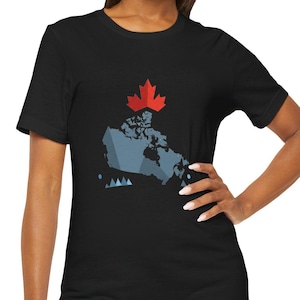 May include: Black t-shirt featuring a graphic of the Canadian map in blue and gray, topped with a red maple leaf. The shirt is a crew neck style and is made of a soft material.