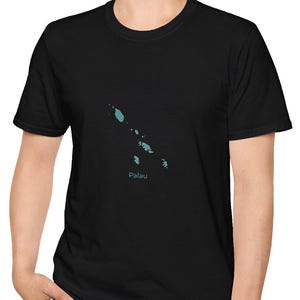 May include: Black t-shirt with a light blue map of Palau and the country's name. The shirt is worn by a person in blue jeans. The t-shirt is made of a soft material.