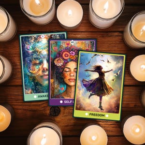 May include: Three tarot cards with vibrant illustrations and text, including "AWAKE", "SELF LOVE", and "FREEDOM". The cards are on a wooden surface, surrounded by lit candles.