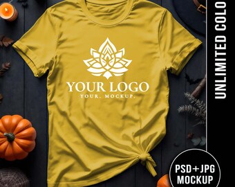 May include: Mustard yellow t-shirt with a white floral logo and the text "YOUR LOGO YOUR. MOCKUP." The shirt is knotted at the bottom. The image includes pumpkins, candles, and the text "UNLIMITED COLORS" and "PSD+JPG MOCKUP."