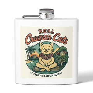 May include: A white hip flask with a silver cap and hinge. It has a colourful graphic of a cartoon cat wearing a flower lei, with text reading "Real Cruzan Cats" and "St. Croix - U.S. Virgin Islands."