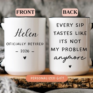 May include: A white ceramic mug with a black handle and rim. The front displays the text 'Helen OFICIALLY RETIRED - 2026 -' with a heart icon. The back features the text 'EVERY SIP TASTES LIKE ITS NOT MY PROBLEM anymore' with a heart icon.