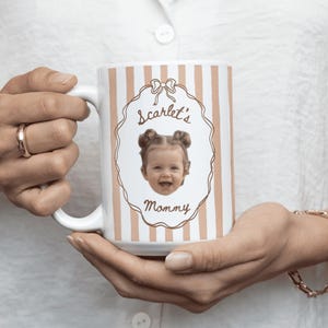 Personalized coffee mug with light brown vertical stripes, featuring a baby portrait with elegant floral frame, custom keepsake gift for Mom, Dad and grandparents