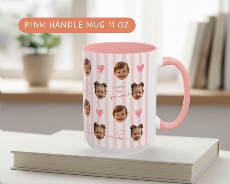 White ceramic mug with a pink and interior. The mug features a pattern of baby faces, pink hearts, and the text "I Love You Grandpa" on a rose striped background.