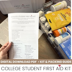 May include: A white paper information sheet titled College Student First Aid Kit with fields for emergency contacts and health information, positioned next to a clear plastic container filled with various over-the-counter medications and supplies.