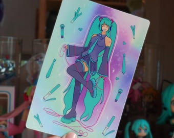 May include: A rectangular sticker featuring a stylized anime character with long teal hair, wearing a purple outfit and headphones. The background has teal and pink accents with microphones, ties, and hearts.