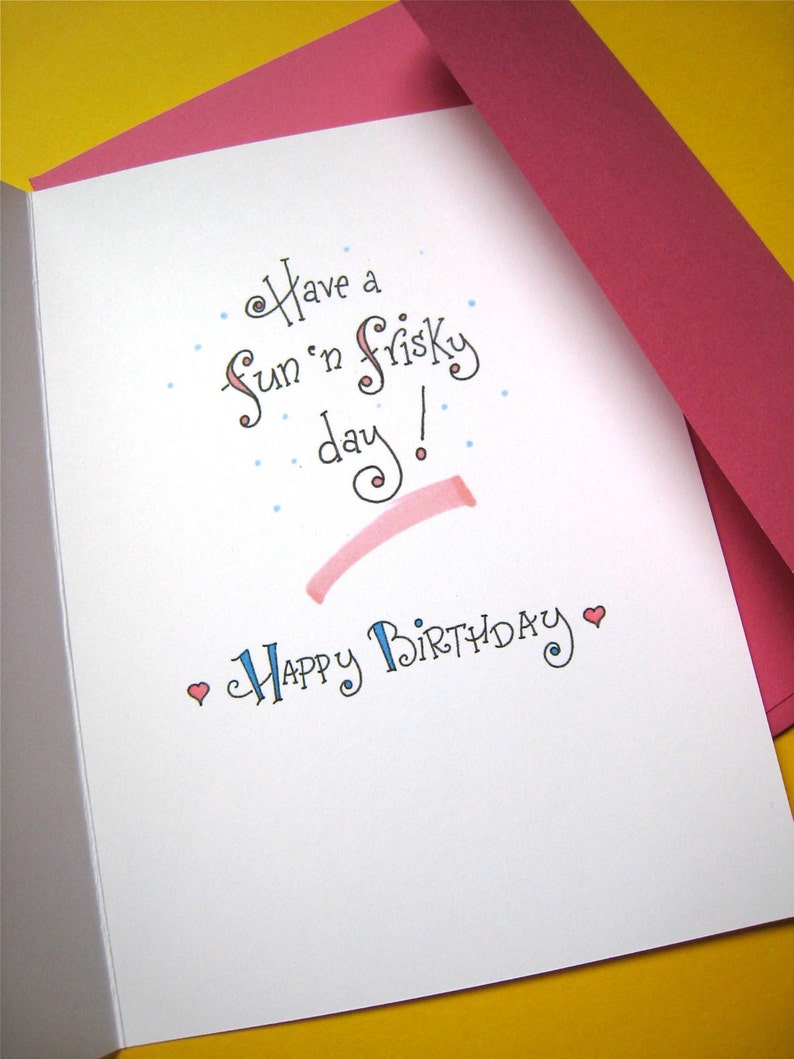 May include: A white card with a pink envelope. The card has blue and pink lettering that says "Have a fun 'n frisky day!" and "Happy Birthday".