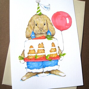May include: A watercolor illustration of a brown bunny wearing a blue and white outfit and a green party hat. The bunny is holding a carrot cake with a red frosting and green leaves. The bunny is also holding a pink balloon with the word "YAY!" written on it.
