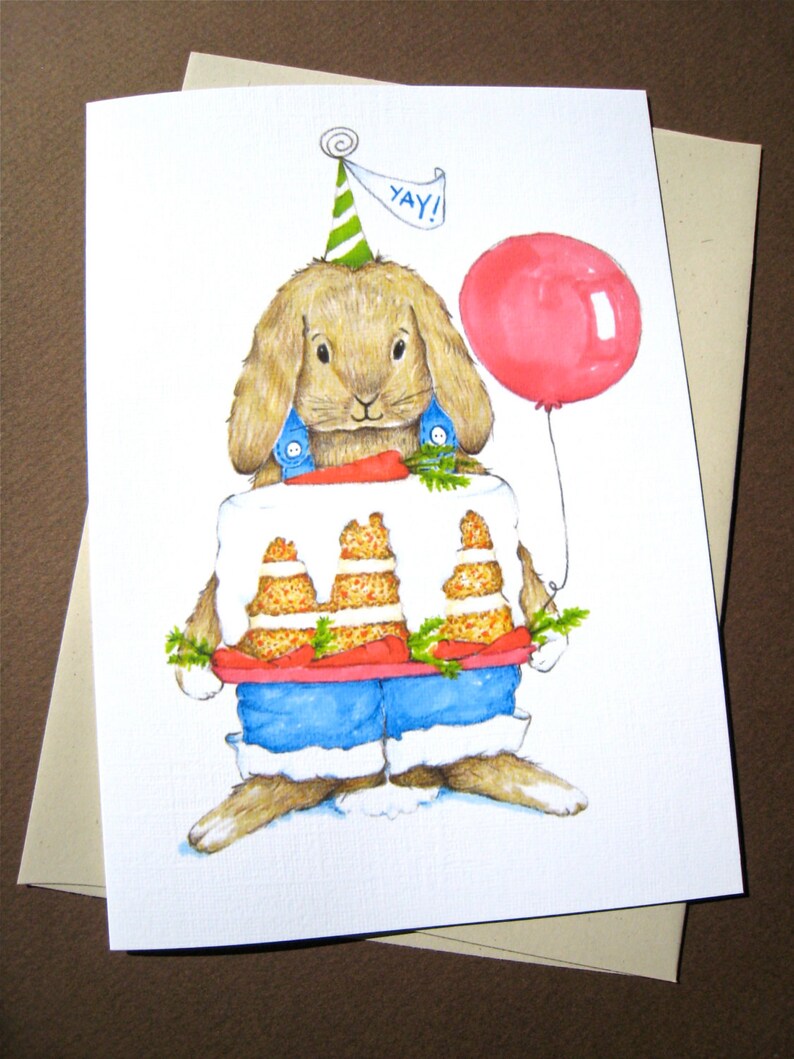 May include: A watercolor illustration of a brown bunny wearing a blue and white outfit and a green party hat. The bunny is holding a carrot cake with a red frosting and green leaves. The bunny is also holding a pink balloon with the word "YAY!" written on it.