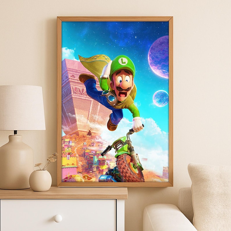 May include: Framed print depicting a cartoon character in a green hat and cape riding a green motorcycle. The background shows a colourful alien landscape with pyramids and planets. The character is mid-air, with a surprised expression.
