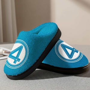 May include: A pair of blue plush slippers with a black sole. Each slipper features a white circle with a blue number 4 inside. The interior of the slippers is a soft, light blue material.