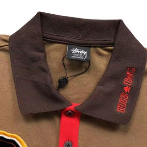Close-up of brown polo collar with contrasting dark collar and button placket