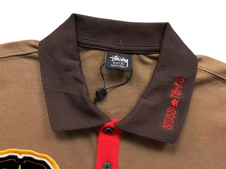 Close-up of brown polo collar with contrasting dark collar and button placket