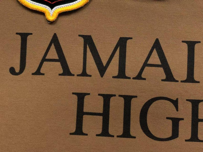 Detailed close-up of embroidered “Jamaica High” lettering