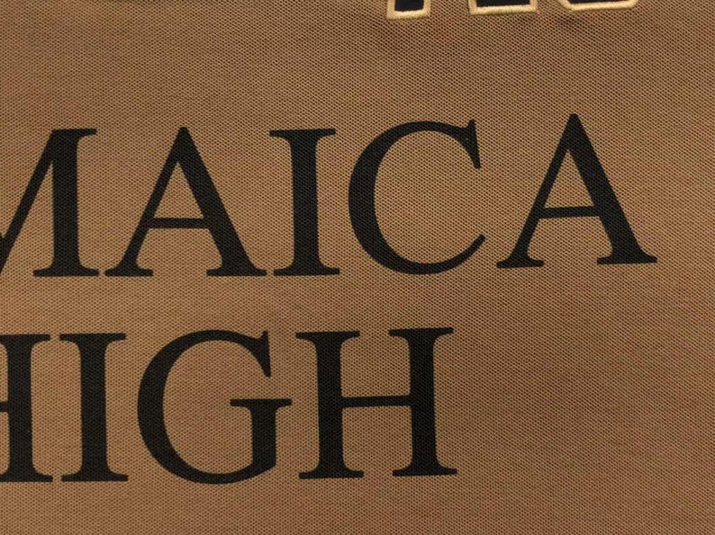 Detailed close-up of embroidered “Jamaica High” lettering