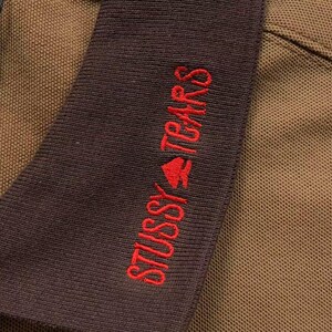 Close-up of sleeve embroidery with red text detail
