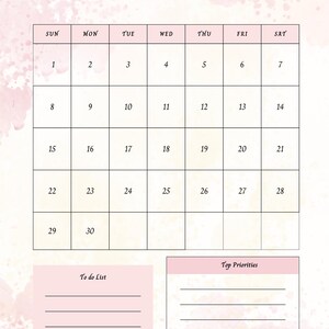 Op de afbeelding: Een roze en witte november 2026 kalender met een aquarelontwerp. De kalender bevat een takenlijst en een sectie voor topprioriteiten. Het woord "November" is in groene letters geschreven.